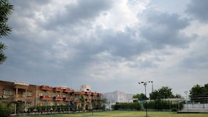 A grassy field with a building in the background. - Udaigarh Palace - The Heritage Hotel  (Jodhpur)
