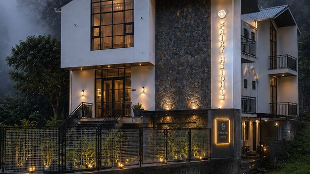 A modern two-story building with a stone facade, large windows, and a balcony. - Fairy heights  (Kodaikanal)