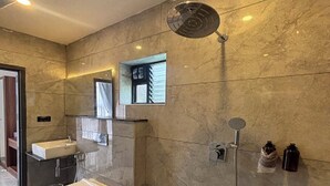 A modern bathroom with a toilet, sink, and shower. - Fairy heights  (Kodaikanal)