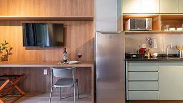 A modern kitchen with a built-in TV, a refrigerator, and a microwave.