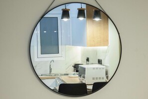 A kitchen with a sink, countertop, and a microwave. - Modern Designer 1 Bd Apt in Central Athens (Athina)