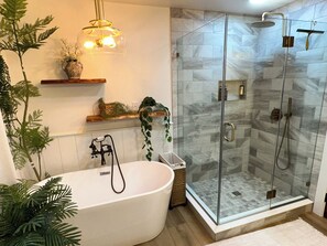 A modern bathroom with a freestanding bathtub, a glass-enclosed shower, and decorative plants. - Shadow Ridge Farm & Retreat - Pool, Hot Tub, Pickleball & Pond - sleeps 35 (Three Springs)