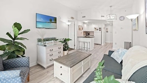 A modern apartment with a kitchen, dining area, and living room. - HS-0111 Ocean Front | Pool | Hot Tub | Lazy River (Myrtle Beach)