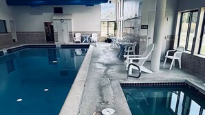 An indoor swimming pool with lounge chairs and a view of the outdoors. - Perfect Peace by the Lake (Keystone)