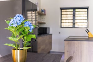 A kitchen with a wooden countertop, a sink, and a window with blinds. - Mambo Stay,  luxury apartment with Hot Tub (Willemstad)
