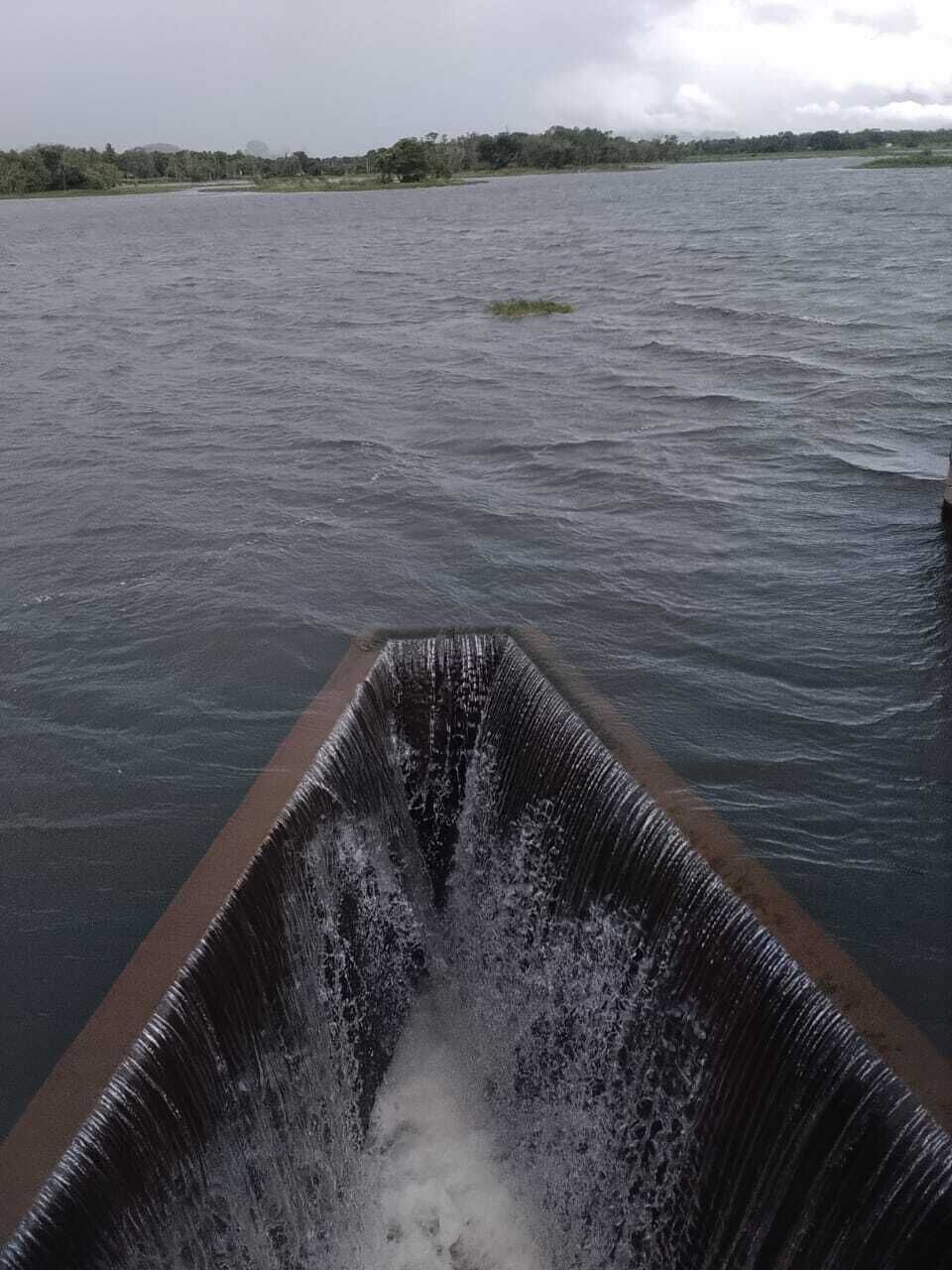 A water channel with a boat in the foreground and a distant shoreline.