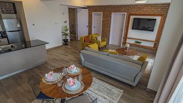 Deluxe Apartment | Living area | 42-inch flat-screen TV with digital channels