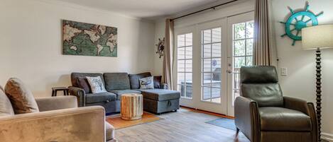 A living room with a sofa, armchair, and a coffee table.