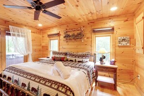A wooden cabin bedroom with a bed, nightstand, and a ceiling fan. - Decks, Hot Tubs & More! 2-unit Base in Blue Ridge (Blue Ridge)
