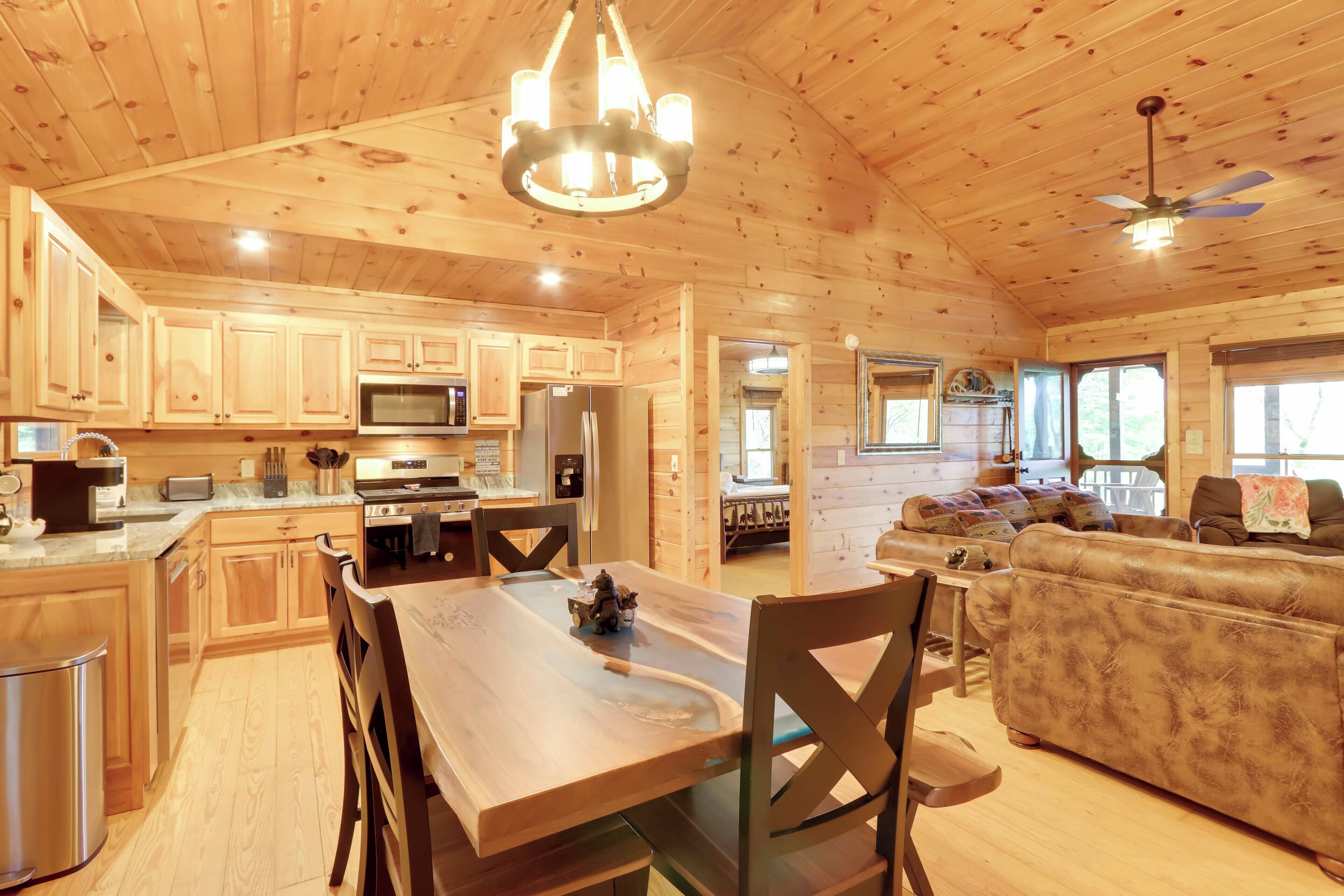 A spacious wooden cabin with a dining area, kitchen, and living room.