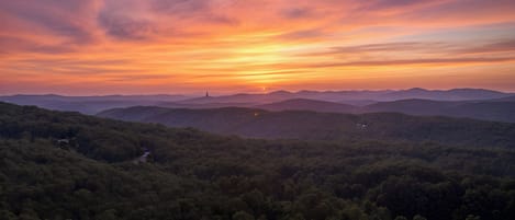 A mountainous landscape with a sunset.