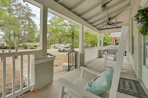 A covered porch with white railings, a bench, and a welcome mat. - 5 Mi to University of South Carolina: Home w/ Yard (Columbia)