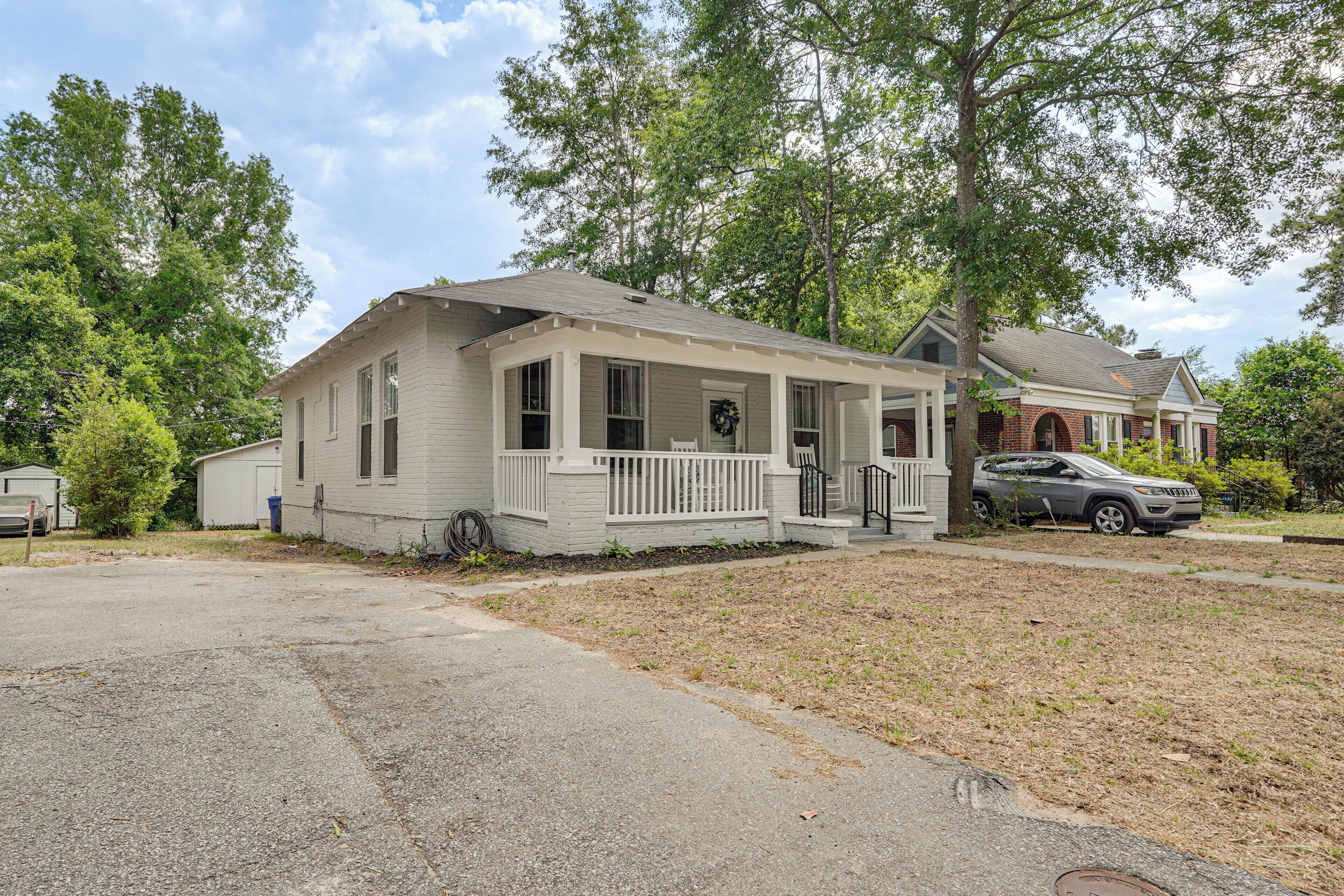 A single-story house with a front porch, a garage, and a driveway.