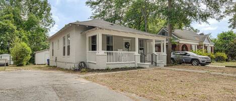 A single-story house with a front porch, a garage, and a driveway.