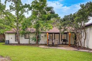A residential house with a patio, outdoor seating, and a covered area. - < 2 Mi to Dallas Stadium! Work & Play Base w/ Yard (Arlington)
