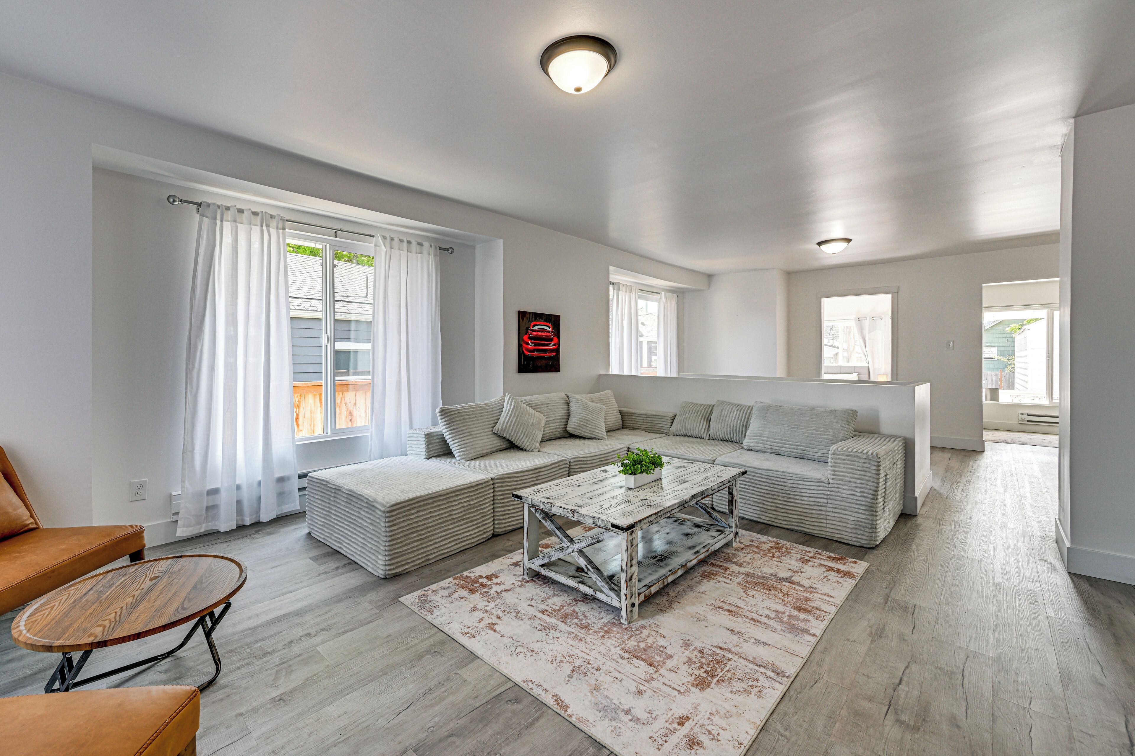 A modern living room with a sofa, a coffee table, and a rug.
