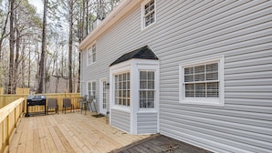 A house with a deck, a barbecue grill, and a covered outdoor seating area. - Centrally Located Fayetteville Home: Deck + Yard (Fayetteville)