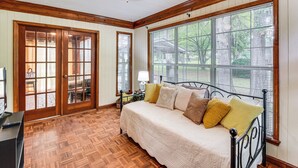 A bedroom with a bed, wooden floor, large windows, and a ceiling fan. - Walkable Location! Peaceful Toccoa Escape w/ Yard (Toccoa)