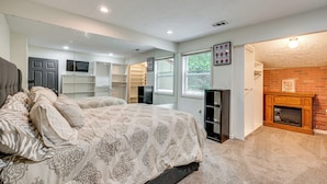 A bedroom with a bed, a fireplace, a mirror, and a closet. - 3BR Townhome Near Downtown Decatur (Decatur)