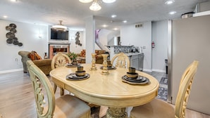 A dining area with a wooden table, chairs, and a chandelier. - 3BR Townhome Near Downtown Decatur (Decatur)