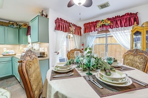 A dining area with a table set for four, chairs, and a window with curtains. - 4 Mi to Lake Houston! Single-level Home w/ Yard (Humble)