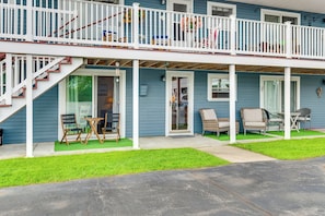 A two-story house with a covered porch, outdoor seating, and a staircase leading to the upper level. - Walk to Wells Beach! Family-friendly Gem w/ Patio (Wells)