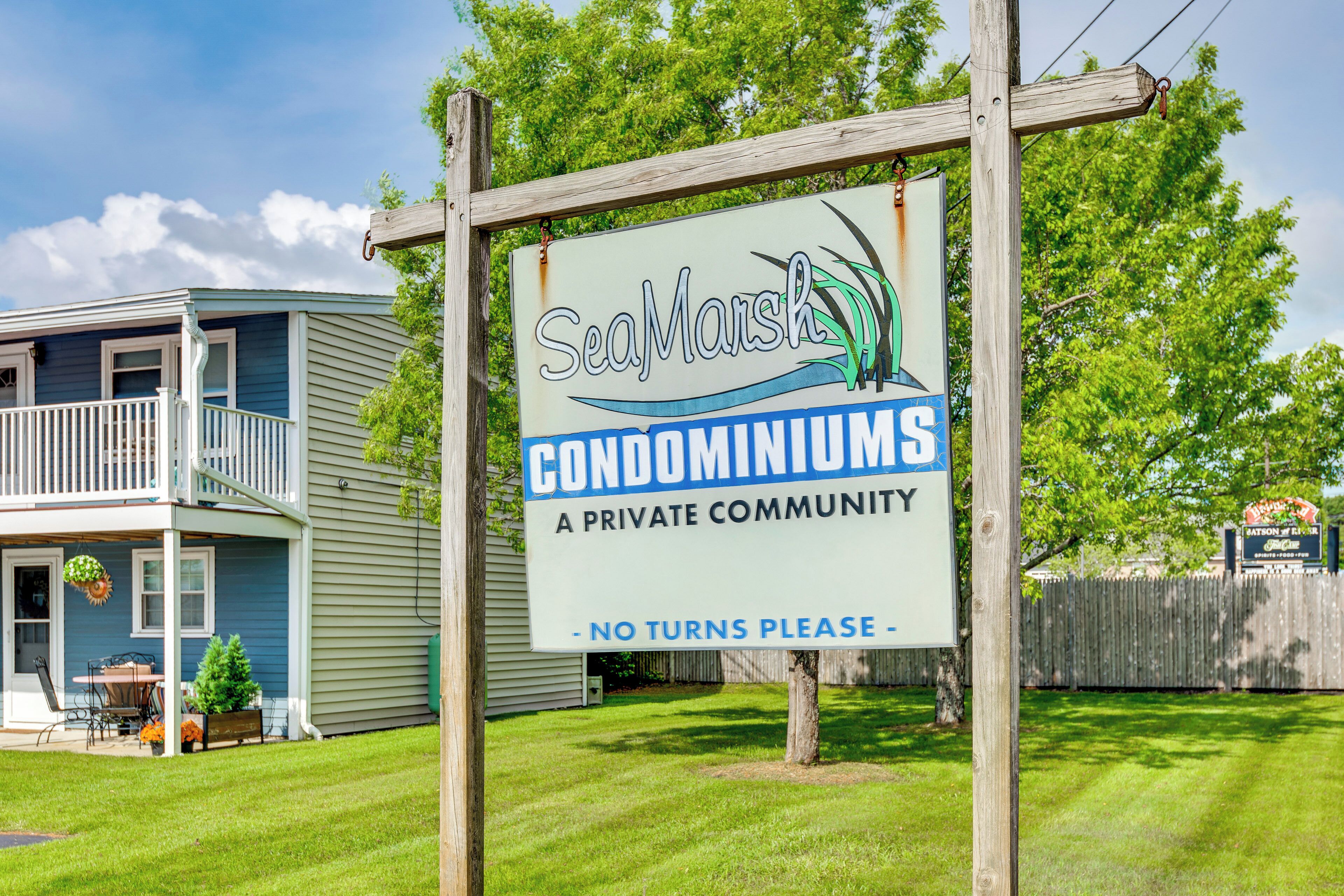 A sign for SeaMarsh Condominiums, a private community, with a no turns please sign.