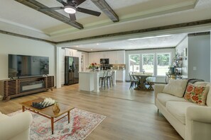A spacious living room with a large TV, a coffee table, and a sofa. - Lake Ridge Cove, Logan Martin Lake Family Retreat! (Talladega)