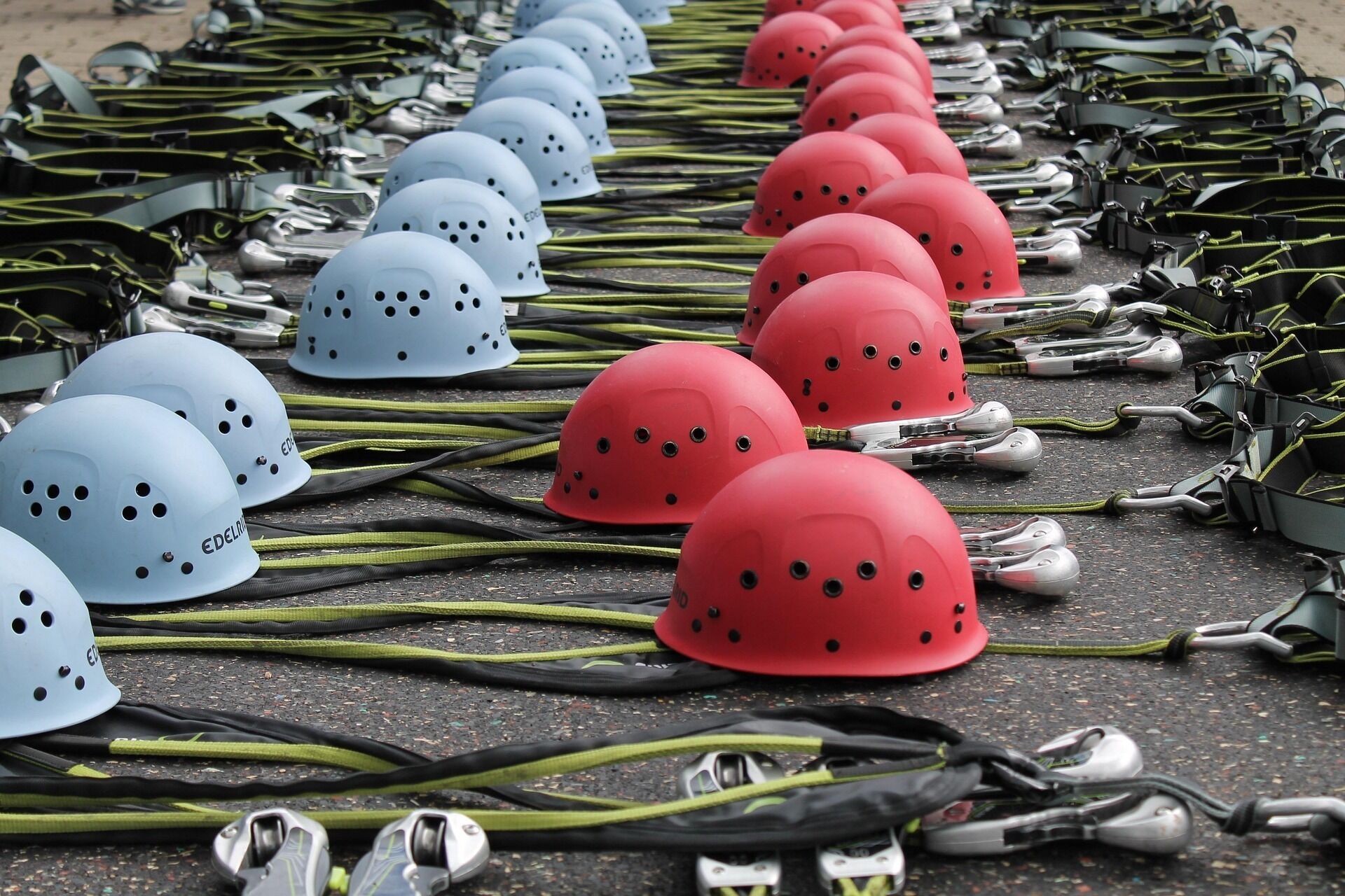 A collection of helmets and protective gear laid out on a surface.