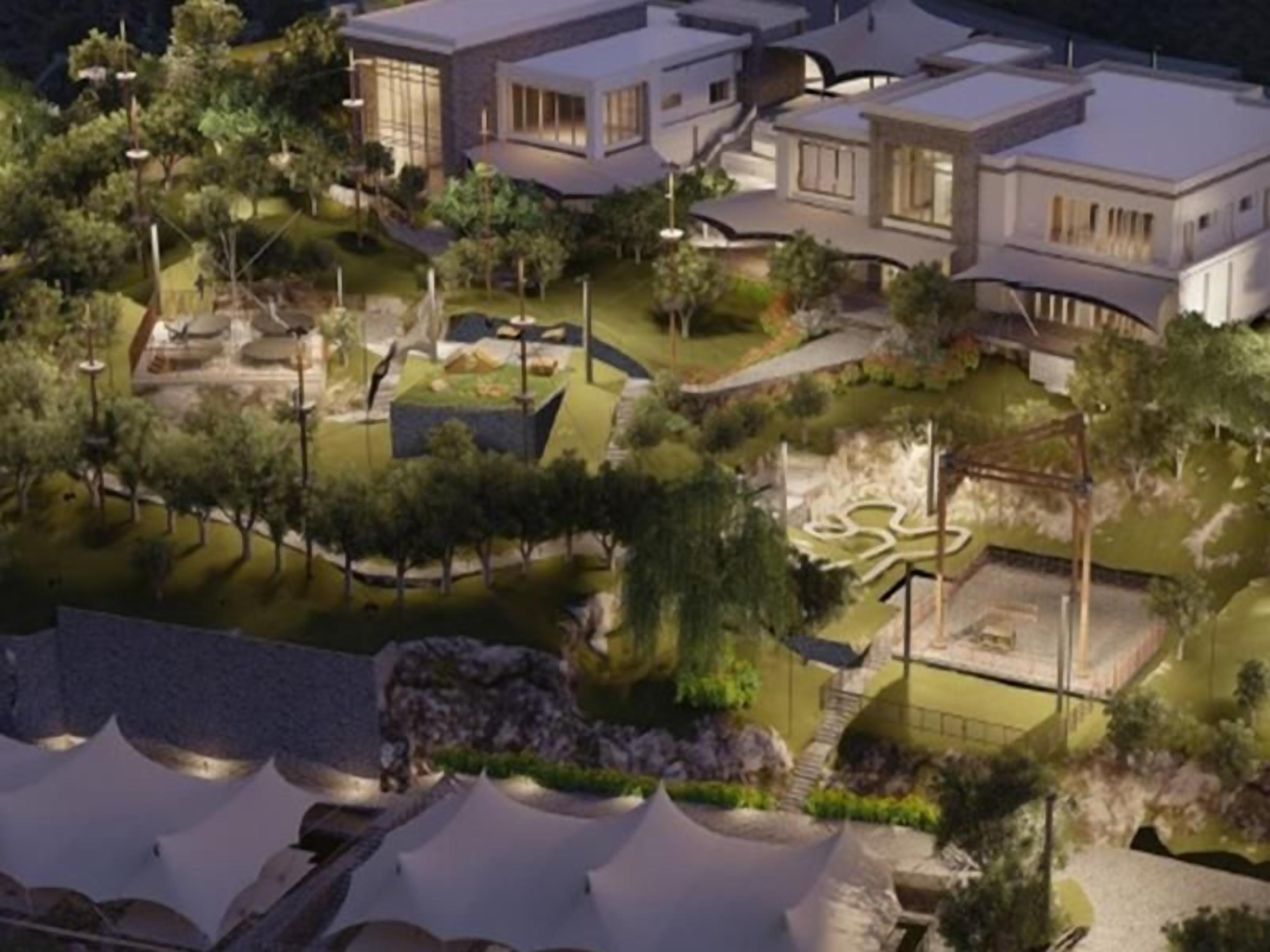 A modern residential complex with multiple houses, landscaped gardens, and a central courtyard.