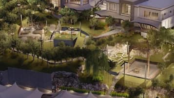 A modern residential complex with multiple houses, landscaped gardens, and a central courtyard.