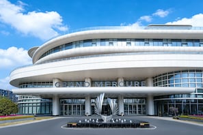 A modern building with the name 'GRAND MERCURE' prominently displayed.