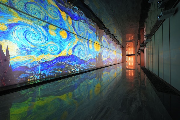 A corridor with a large, colorful mural on the wall.