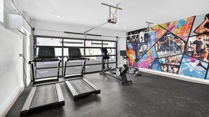 A gym with treadmills, an elliptical, and a stationary bike. - Copper Sky Townhome - Pool & Gym (Phoenix)