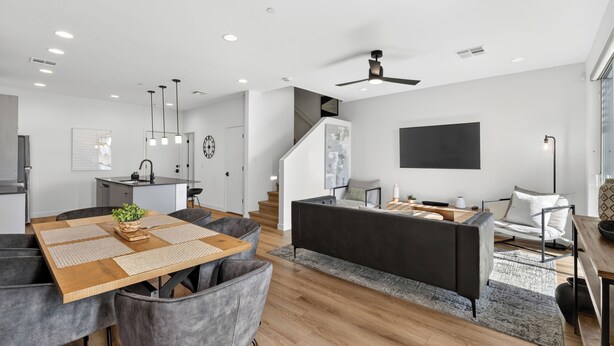 A modern living space with a dining area, kitchen, and seating area. - Copper Sky Townhome - Pool & Gym (Phoenix)