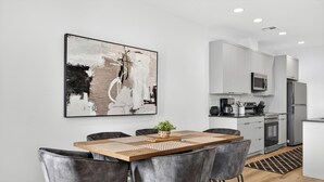 A modern kitchen with white cabinets, a microwave, and a stainless steel refrigerator. - Copper Sky Townhome - Pool & Gym (Phoenix)