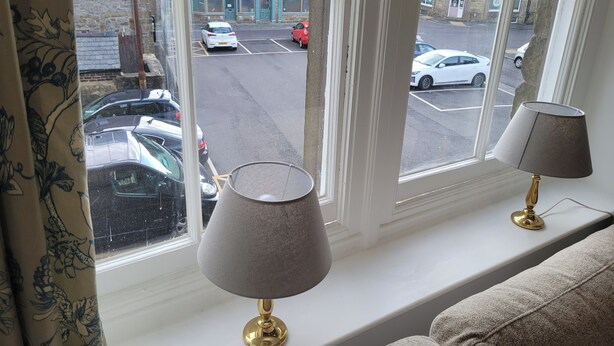 A window with a view of parked cars and a building across the street. - Palace Court in the Heart of Buxton (Buxton)