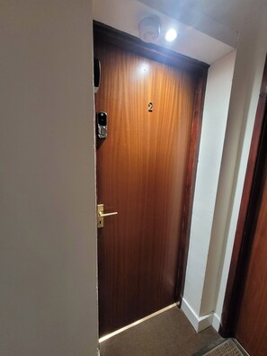 A wooden door with a number '2' and a doorbell. - Palace Court in the Heart of Buxton (Buxton)