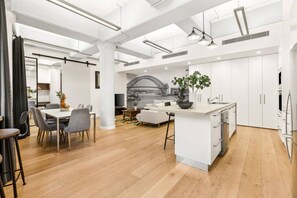 A modern interior with a dining area, kitchen, and living space. - Renovated Warehouse Conversion In Heart Of Sydney! (Dawes Point)