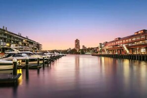 A marina with boats docked, a waterway, and buildings on either side. - Renovated Warehouse Conversion In Heart Of Sydney! (Dawes Point)