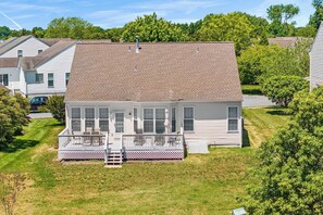 A two-story house with a front porch, a garage, and a well-maintained lawn. - Saltwater Heaven (Rehoboth Beach)