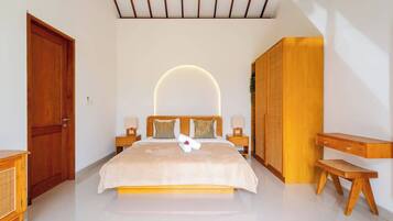A bedroom with a large bed, bedside tables, a wardrobe, and a desk.