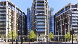 A modern building with a central tower and symmetrical wings, featuring large windows and a glass facade. - Knightsbridge Beauchamp Exclusive II - 46bp (London)