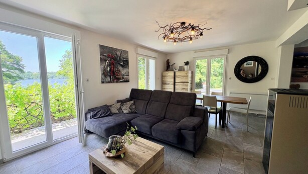 A modern living room with a sofa, coffee table, and artwork.