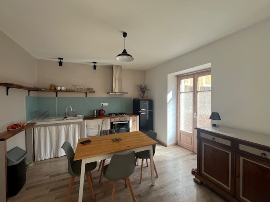 A modern kitchen with a dining area, wooden flooring, and a large window.. A stone's throw from the CENTRE: ALL-CONVENIENCE APARTMENT WITH CLOSE CONVENIENCES!