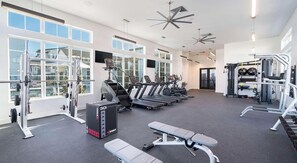 A gym with treadmills, weight machines, and benches. - Landing Amazing 1bd, Clubhouse, Gym (Kyle)