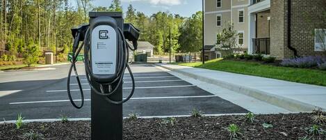 A parking area with a charging station for electric vehicles.