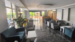 A modern lobby with seating, a reception desk, and large windows. - Citrus Urban (Konyaaltı)