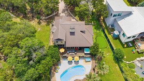 A large house with a swimming pool, deck, and outdoor seating area. - The Lakeside Soundtrack | Pool, Hot Tub, Games (Spicewood)