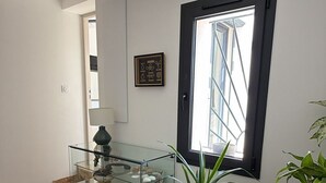 A room with a glass display case, a window with a view, and a potted plant. - House with private spa and large garden - Provence Luberon (La Bastidonne)